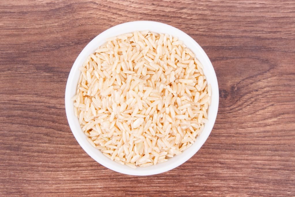 Heap of brown rice in glass bowl