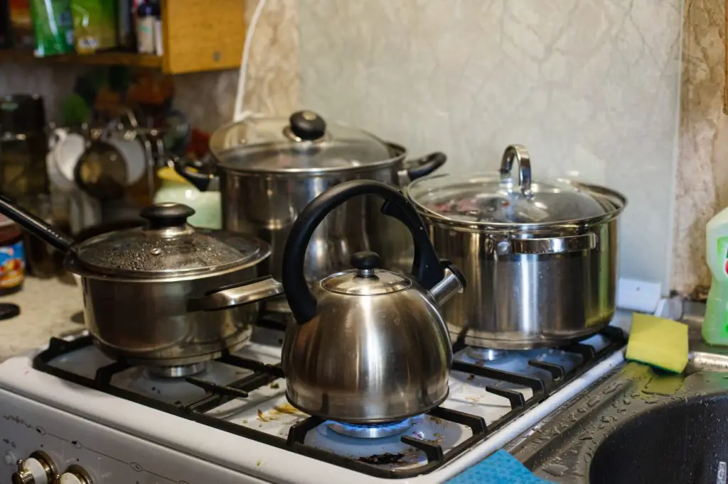 The kettle and pans are on the stove. Cooking in the kitchen