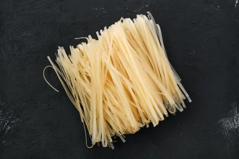 Dry rice stick noodles on black background
