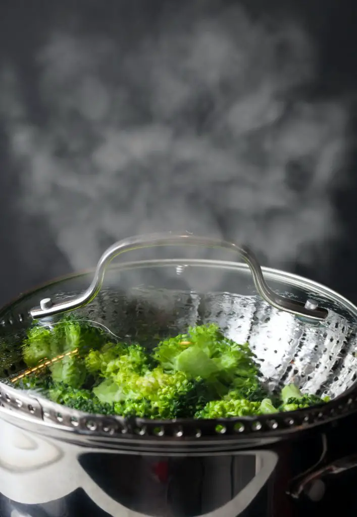Freshly steamed green broccoli in skimmer pot
