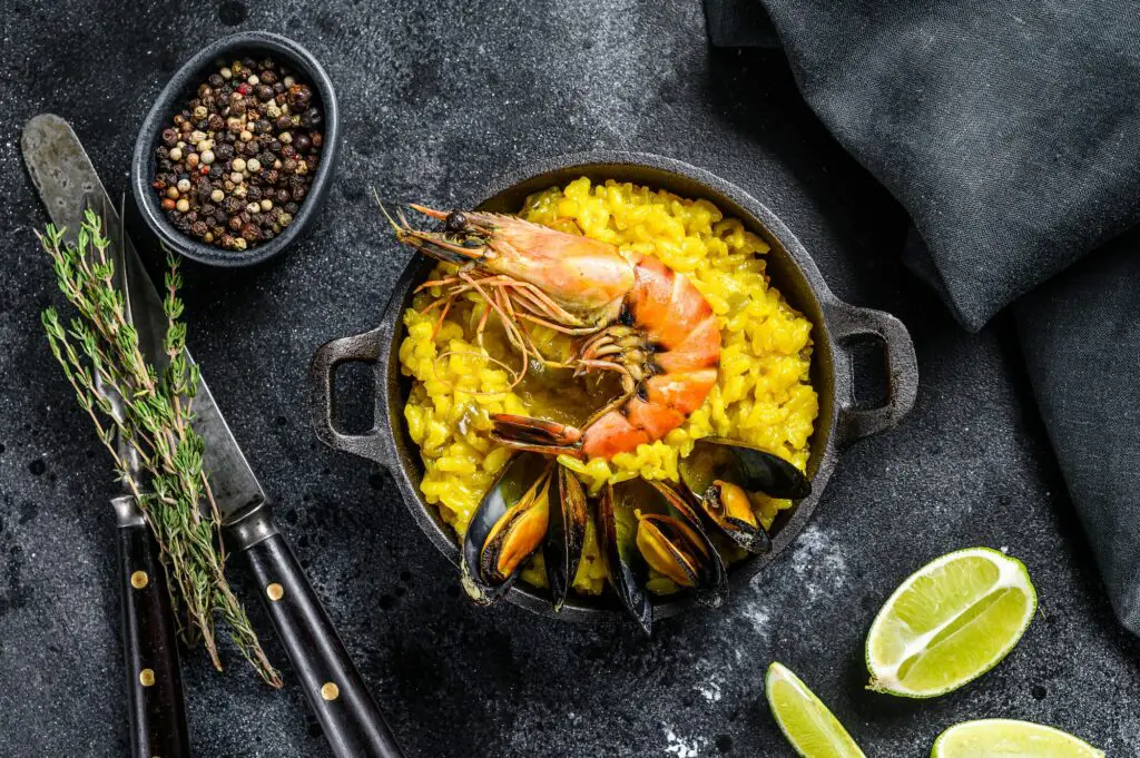 The Spanish Seafood paella in a pan with prawns, shrimps, octopus and mussels.