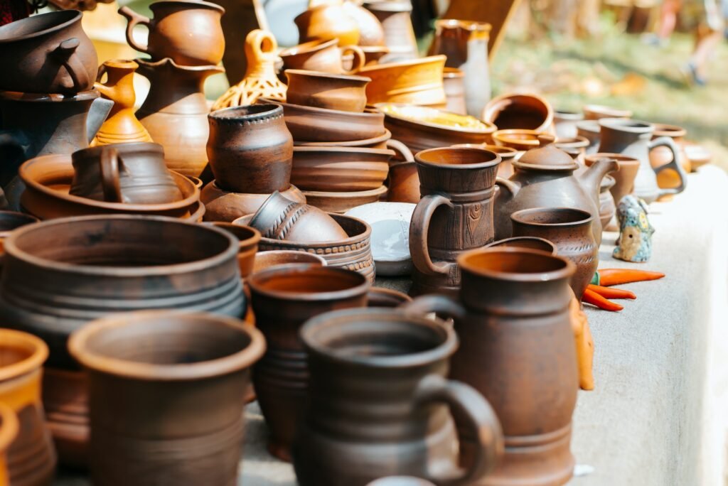 Craft earthenware, handmade ceramic mugs and pots in a medieval rustic style. Sale of kitchen